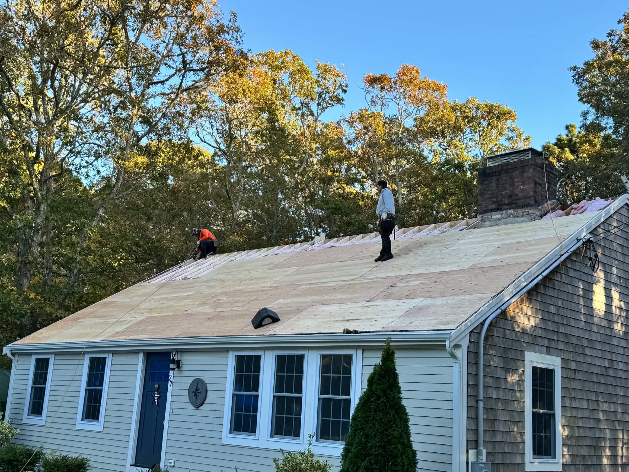 Workers on a home’s roof during a roofing project